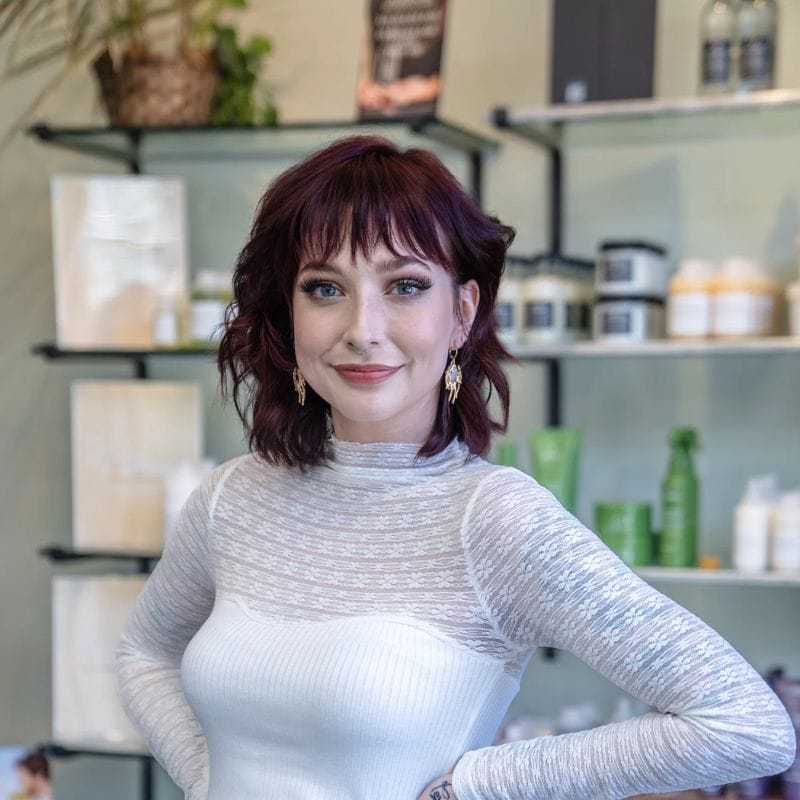 Portrait of Sophie, a professional stylist at Salon Sublime, showcasing their expertise and style.