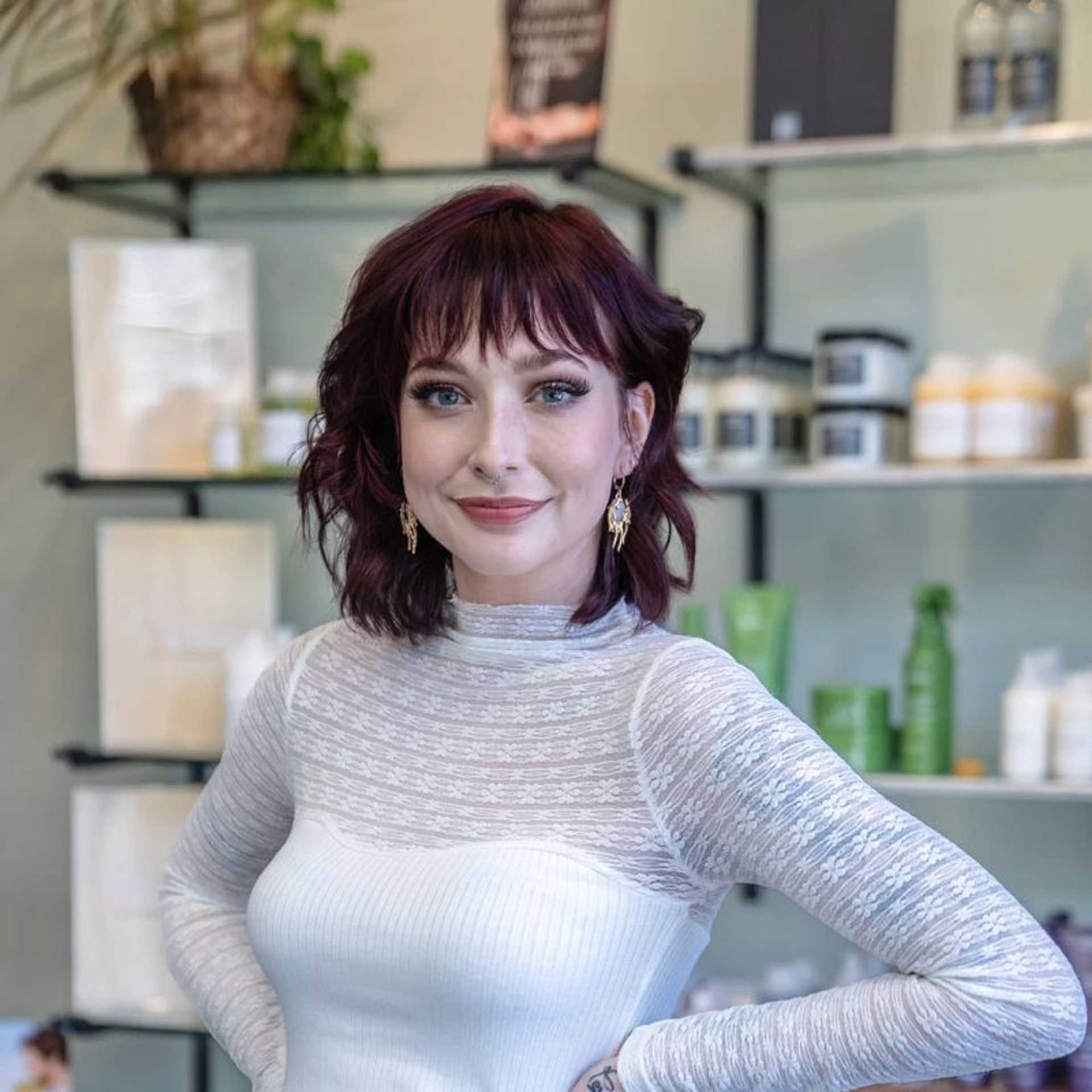 Portrait of Sophie, a professional stylist at Salon Sublime, showcasing their expertise and style.