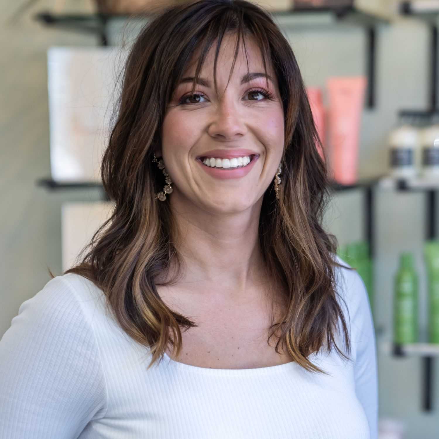 Portrait of Kim, a professional stylist at Salon Sublime, showcasing their expertise and style.