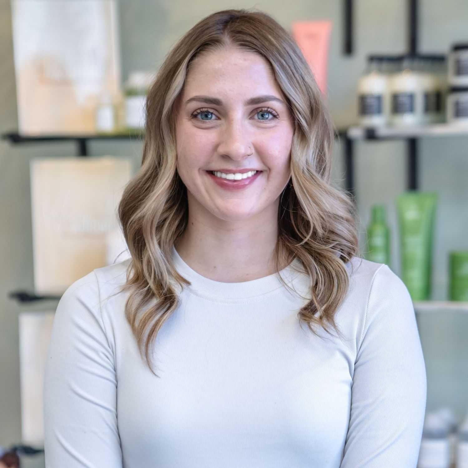 Portrait of Alli, a professional stylist at Salon Sublime, showcasing their expertise and style.